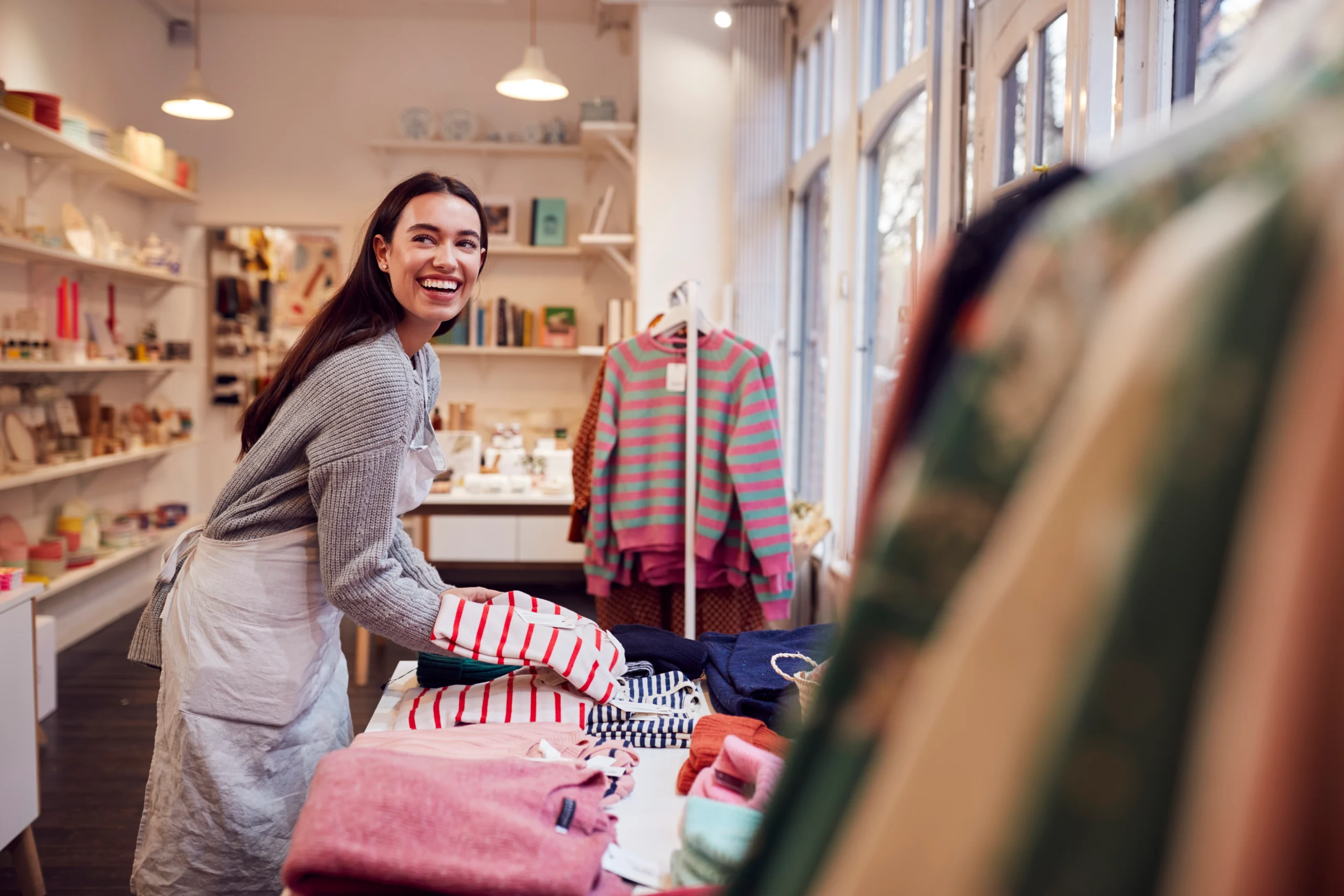 female business owner stocking shelves