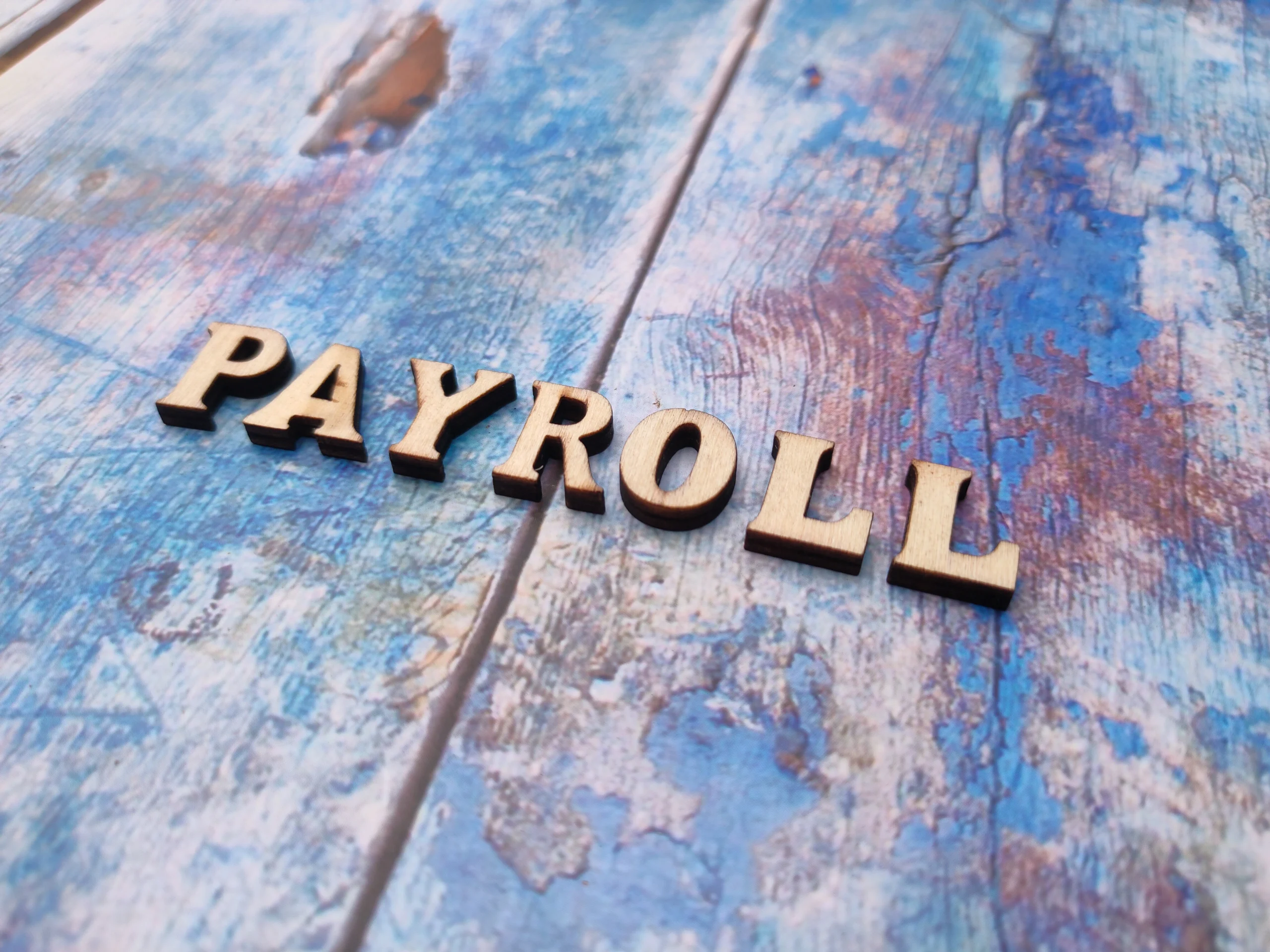Wooden Letters Spelling Payroll